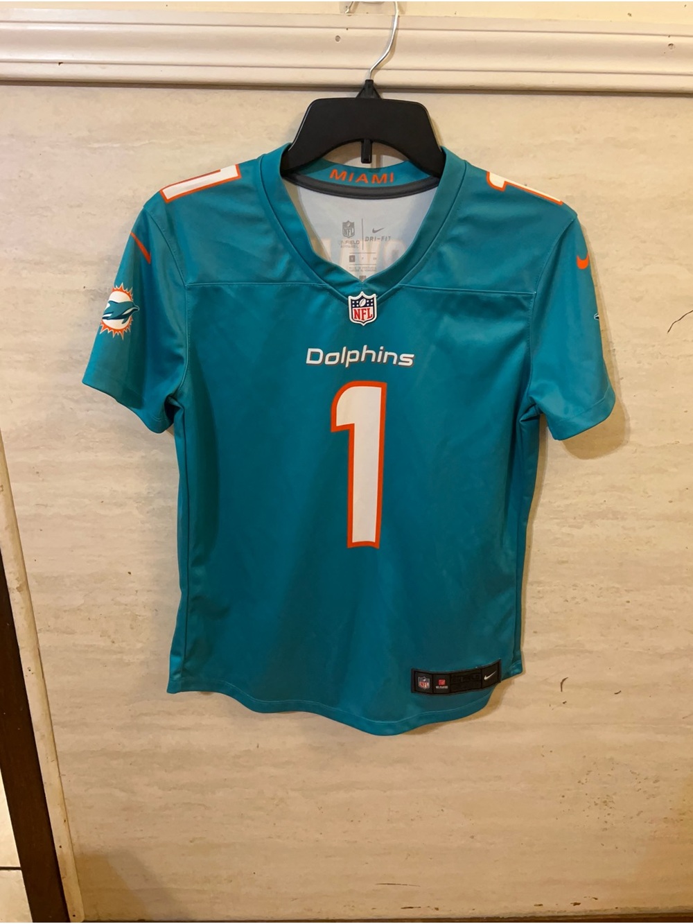 Nike Tua Tagovailoa #1 Miami Dolphins aqua-colored jersey.
